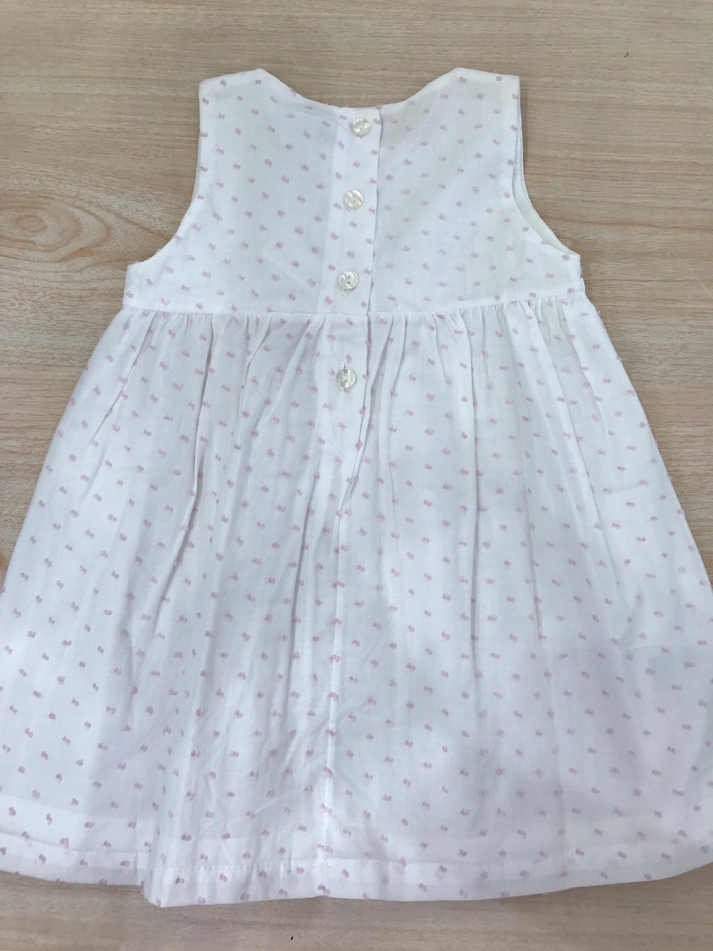 Abito Coccodè in cotone bianco con pois rosa smanicato con fiori in vita