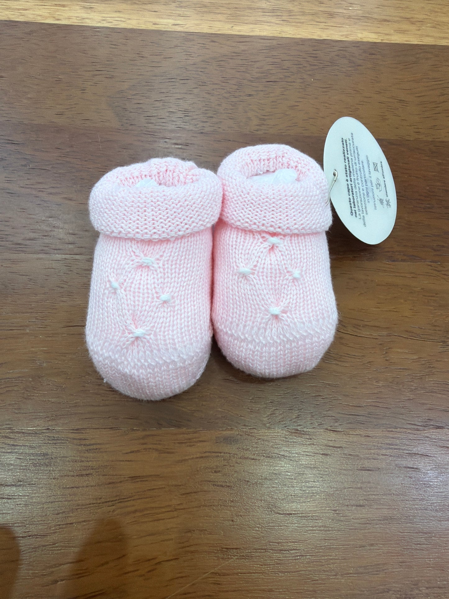 Babbucce Baby Lord in filo rosa con lavorazione di punto smock bianco