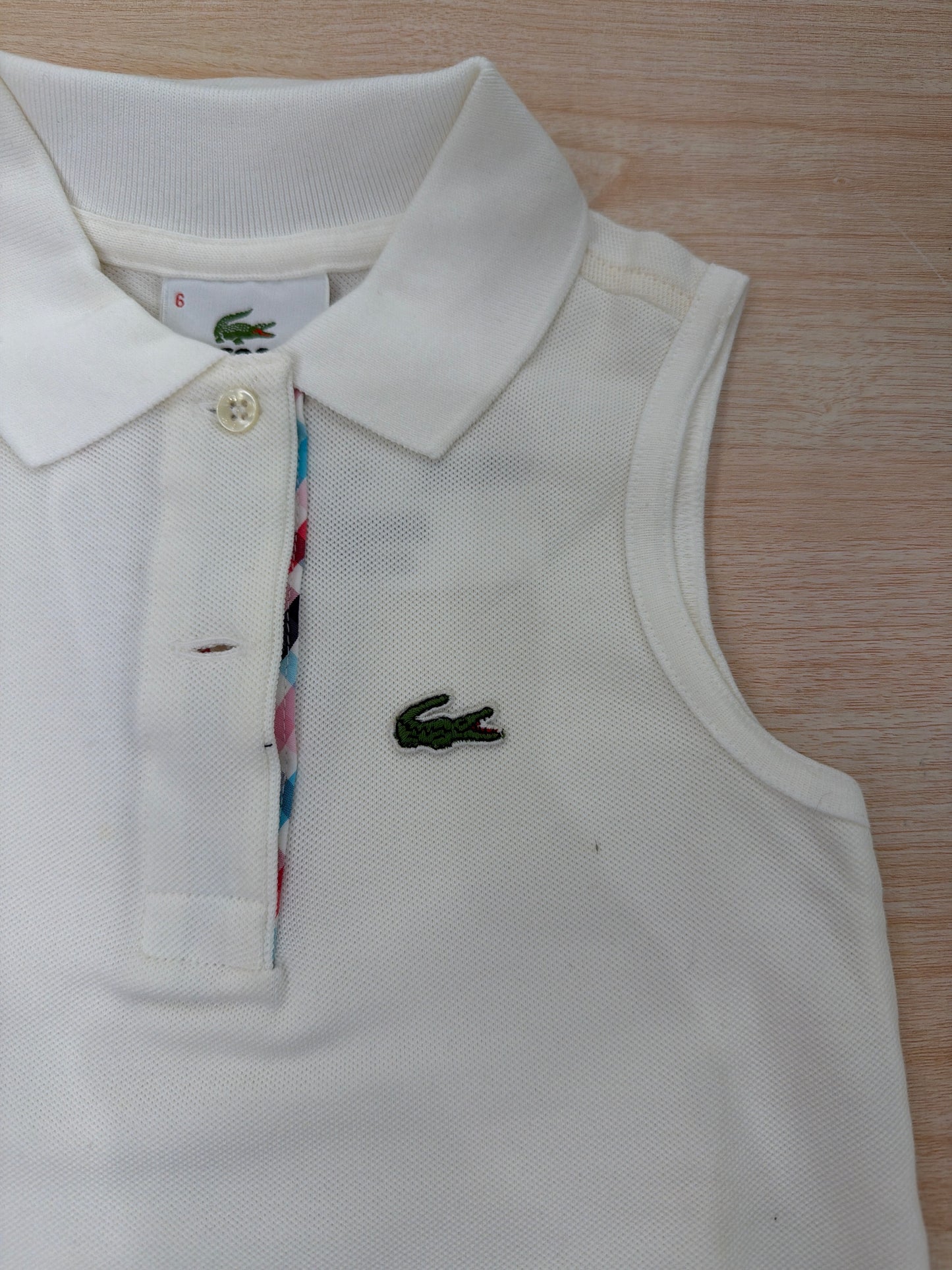 Polo Lacoste in cotone smanicata con bottoncini e logo ricamato lateralmente